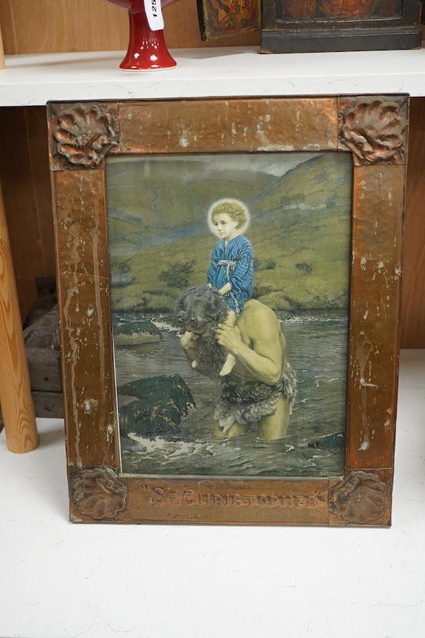 An Arts & Crafts copper picture frame embossed with shells and titled ‘St. Christopher’, housing a print of Saint Christopher carrying the christ child, 46 x 36cm